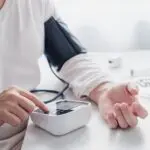 person checking their blood pressure