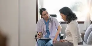woman talking to doctor about osteoporosis