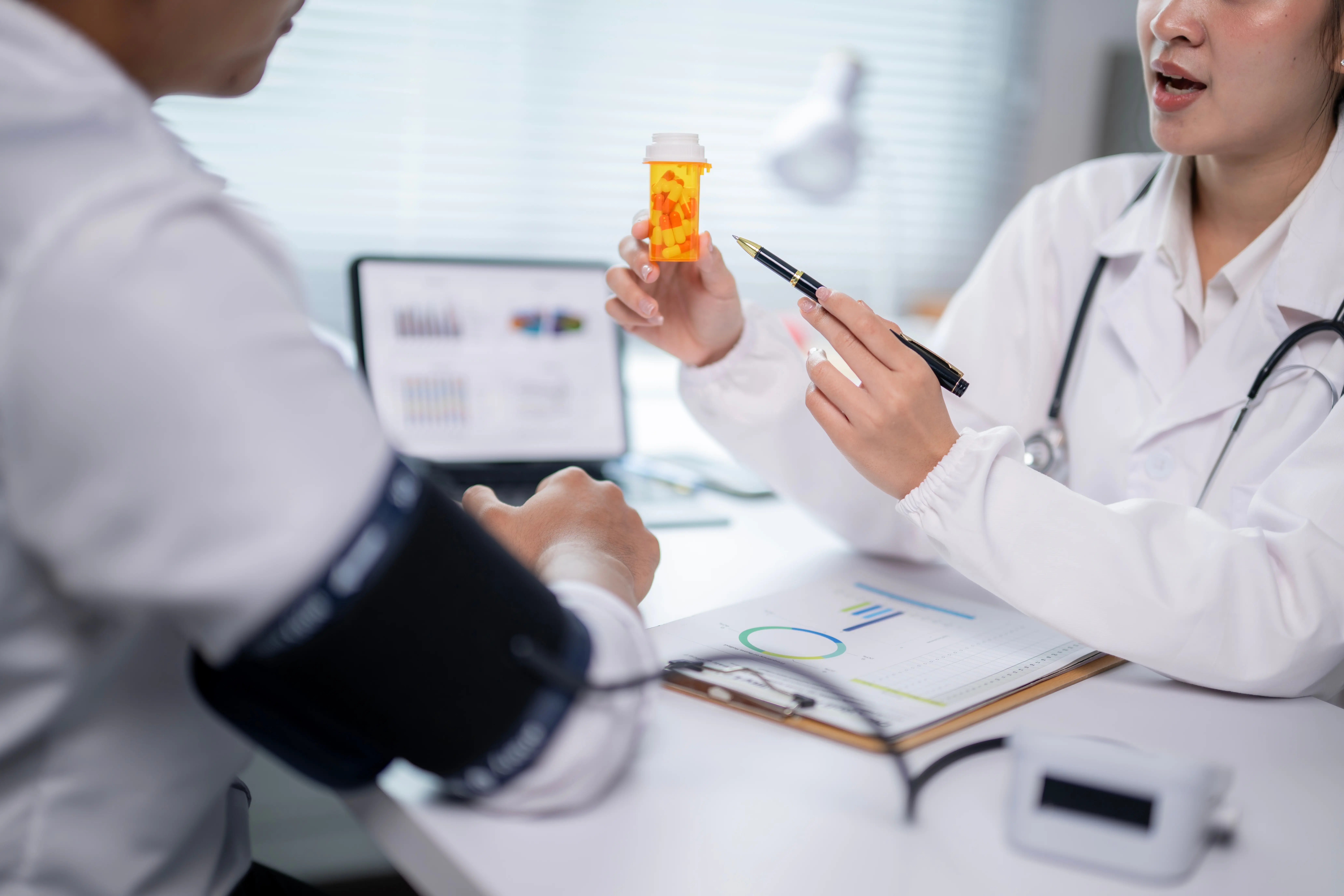 doctor talking to patient with blood pressure cuff