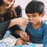 child taking liquid medicine