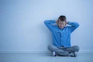 little boy holding his ears