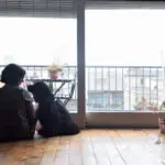 woman looking out with her dog