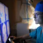 radiologist looking at images of brain