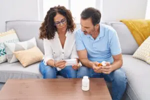 couple looking at pill bottle