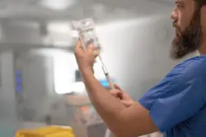 doctor checking intravenous solution