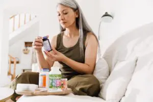woman looking at supplement bottles