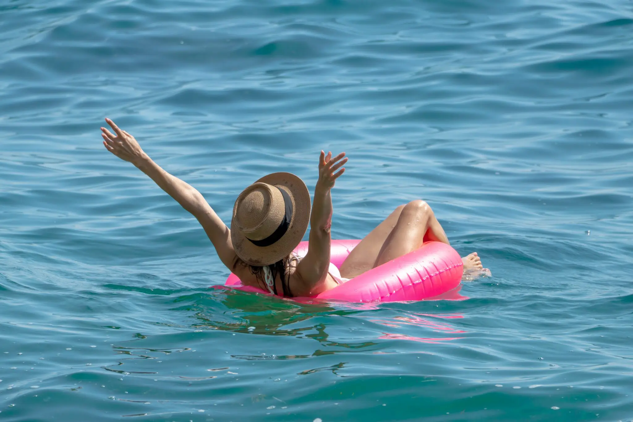 person in an inner tube on a lake