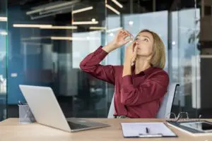 woman putting in eye drops