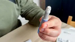 person holding ozempic pen