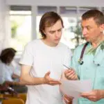 young man talking to doctor about a drug holiday