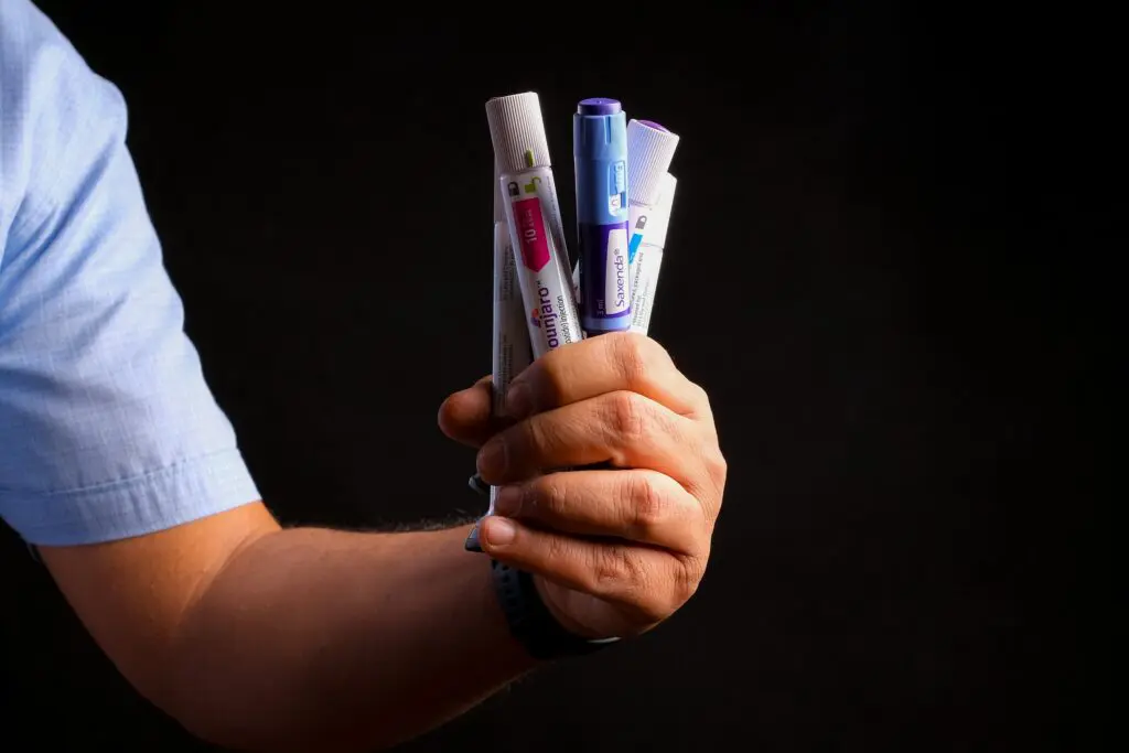 GLP-1 Lawsuits Raise Questions About Vision Loss and Other Serious Side Effects, hand holding GLP-1s
