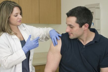 doctor administering the flu shot to a patient