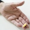 hand holding a pill