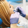 how medications affect your dental health, woman receiving dental care