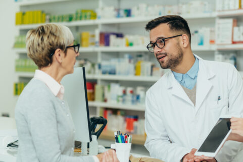 Pharmacist speaking to a senior woman