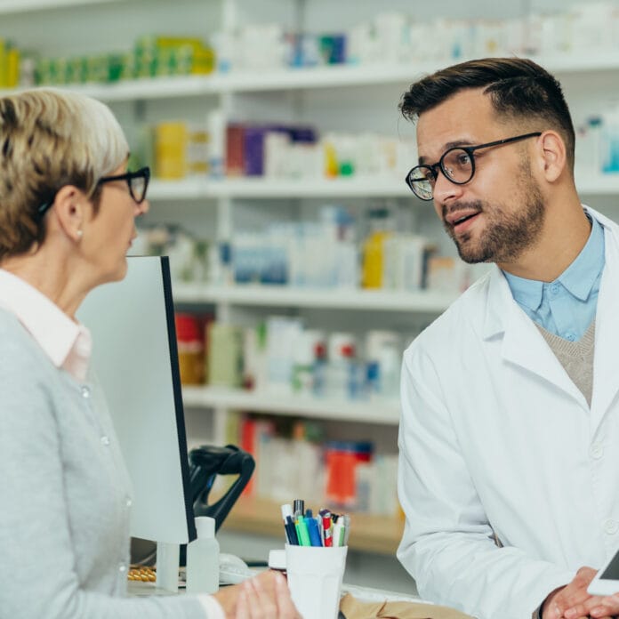 Pharmacist speaking to a senior woman