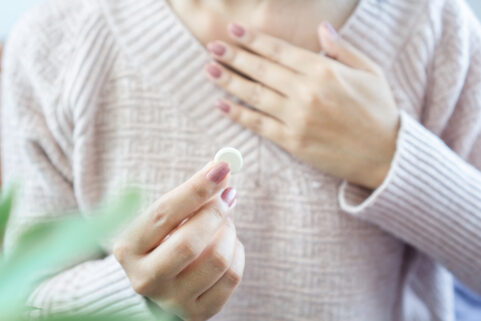 female hand holding antiacid, tums