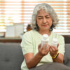 sudafed vs sudafed PE, older woman looking at two medicine bottles