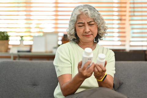 sudafed vs sudafed PE, older woman looking at two medicine bottles