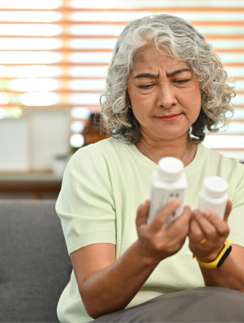 sudafed vs sudafed PE, older woman looking at two medicine bottles