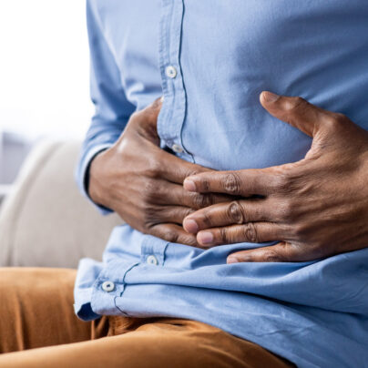 Common GI Issues And The Medications That Treat Them, man holding stomach