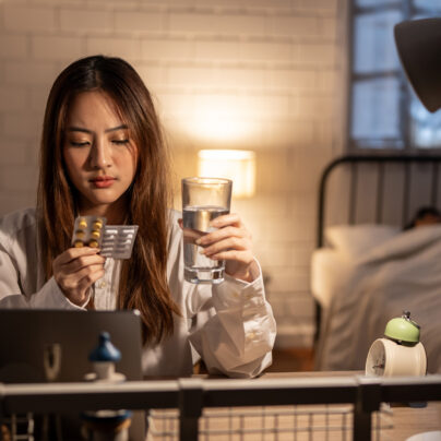 can I take melatonin with ambien? woman sitting on couch looking at pills