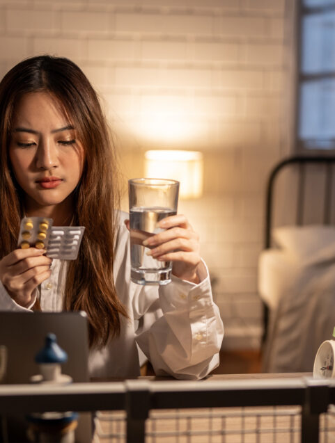 can I take melatonin with ambien? woman sitting on couch looking at pills