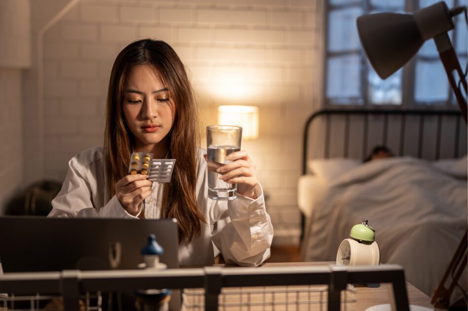 can I take melatonin with ambien? woman sitting on couch looking at pills