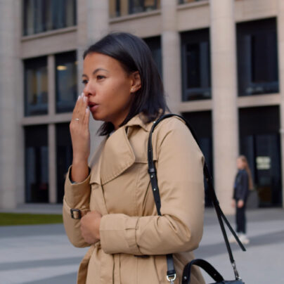 black woman standing cold and sick outside