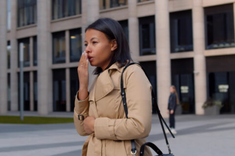 black woman standing cold and sick outside