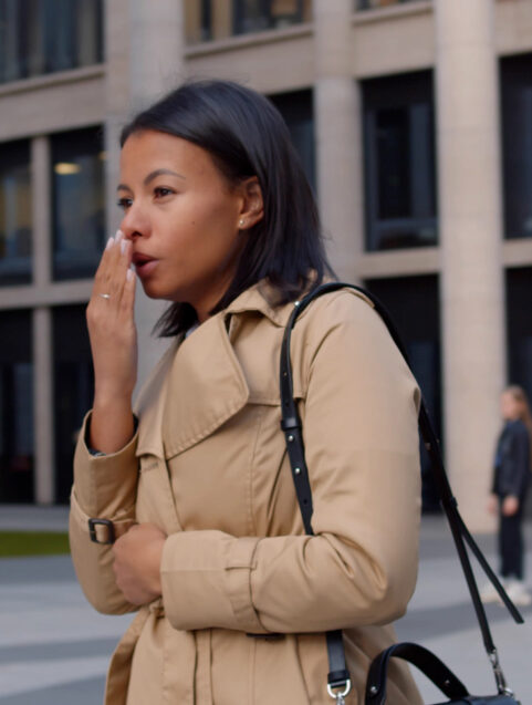 black woman standing cold and sick outside