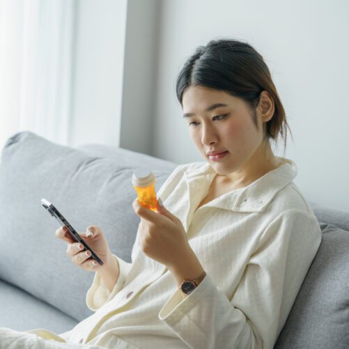 can I take lexapro with st john's wort, woman looking at pill bottled