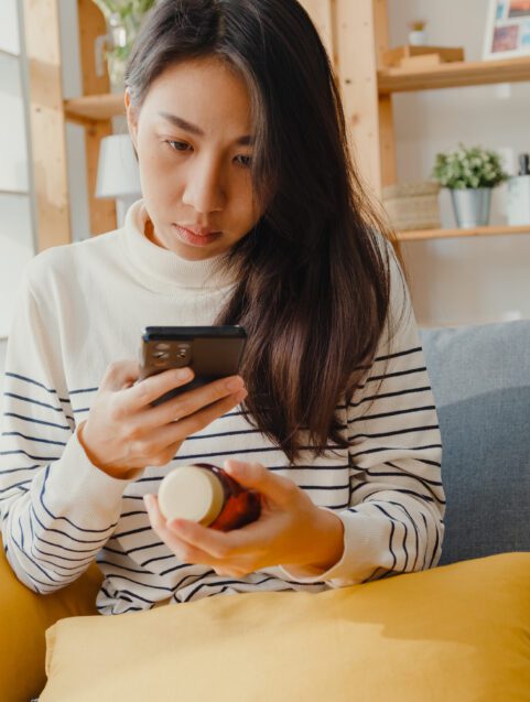 Can I Take Zyrtec with Xanax? woman looking at pill bottle