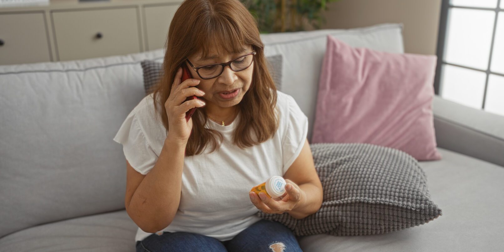 FDA SIDE EFFECTS UPDATE: Antipsychotic Drugs and Breast Cancer Risk , woman looking at pill bottle