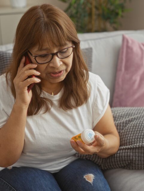 FDA SIDE EFFECTS UPDATE: Antipsychotic Drugs and Breast Cancer Risk , woman looking at pill bottle