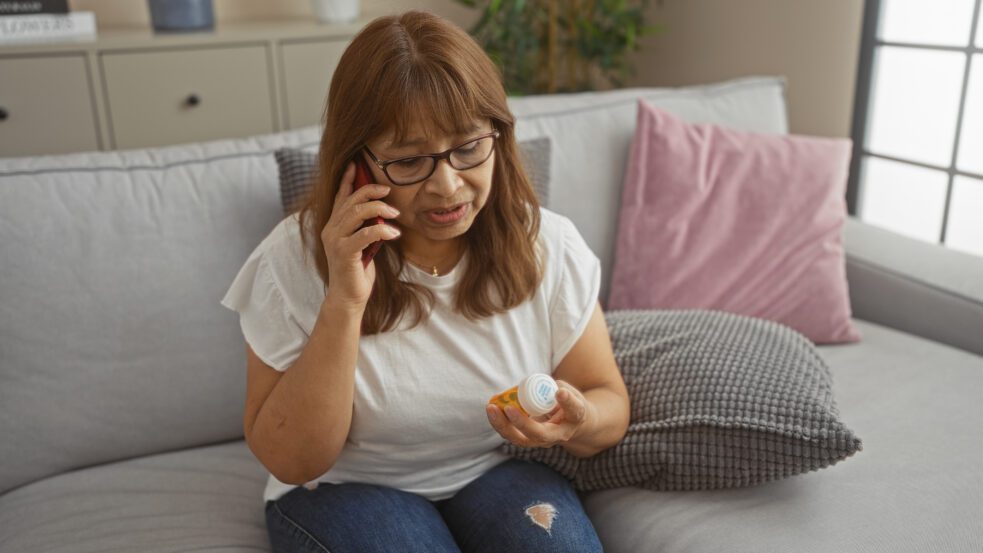 FDA SIDE EFFECTS UPDATE: Antipsychotic Drugs and Breast Cancer Risk , woman looking at pill bottle