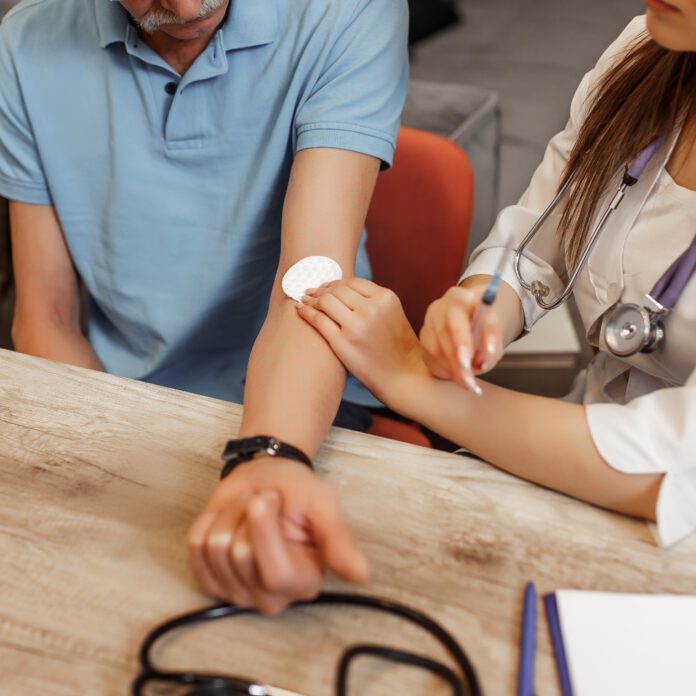 doctor giving older patient an injection, FDA SIDE EFFECTS UPDATE: Gadolinium Contrast Agents (GBCAs) and Severe Lung Problems