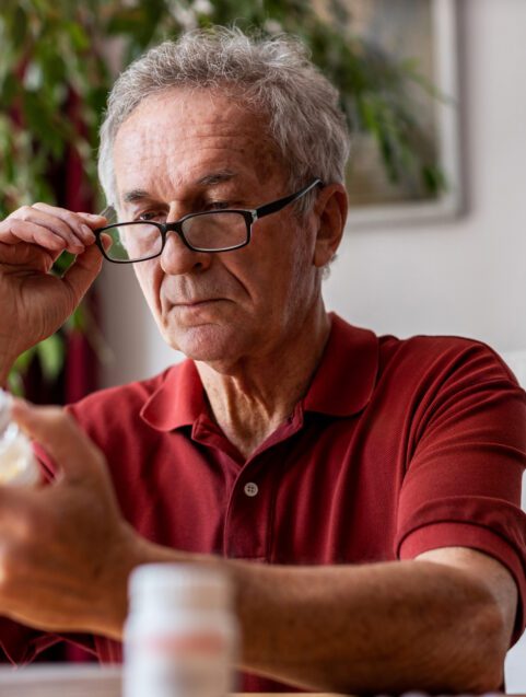 Can I Take Advil with Eliquis? Older man taking pills