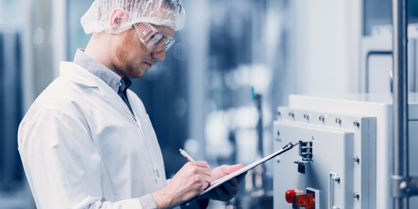 man inspecting drug manufacturing lab