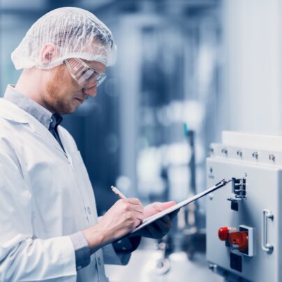man inspecting drug manufacturing lab