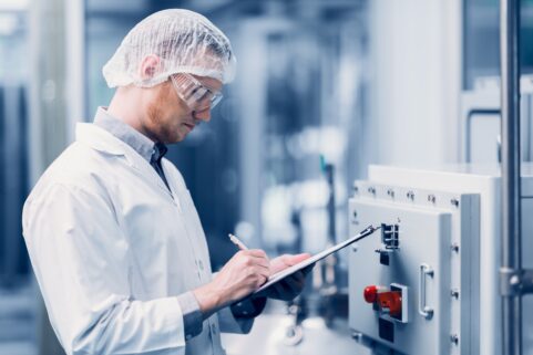 man inspecting drug manufacturing lab