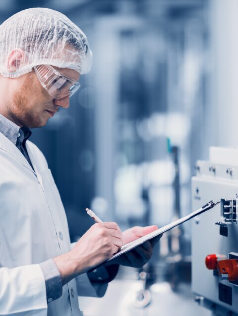 man inspecting drug manufacturing lab