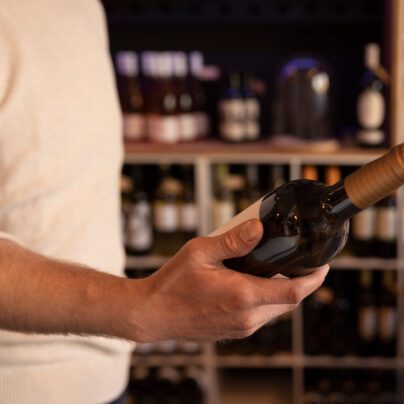 Ozempic and Alcohol, man looking at wine bottle