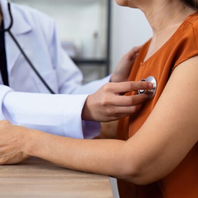 woman in doctor's office heart exam
