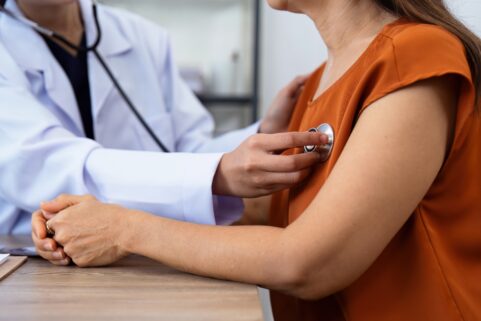 woman in doctor's office heart exam
