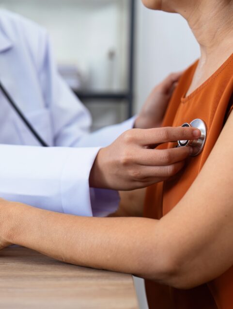 woman in doctor's office heart exam