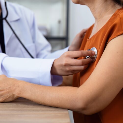 woman in doctor's office heart exam