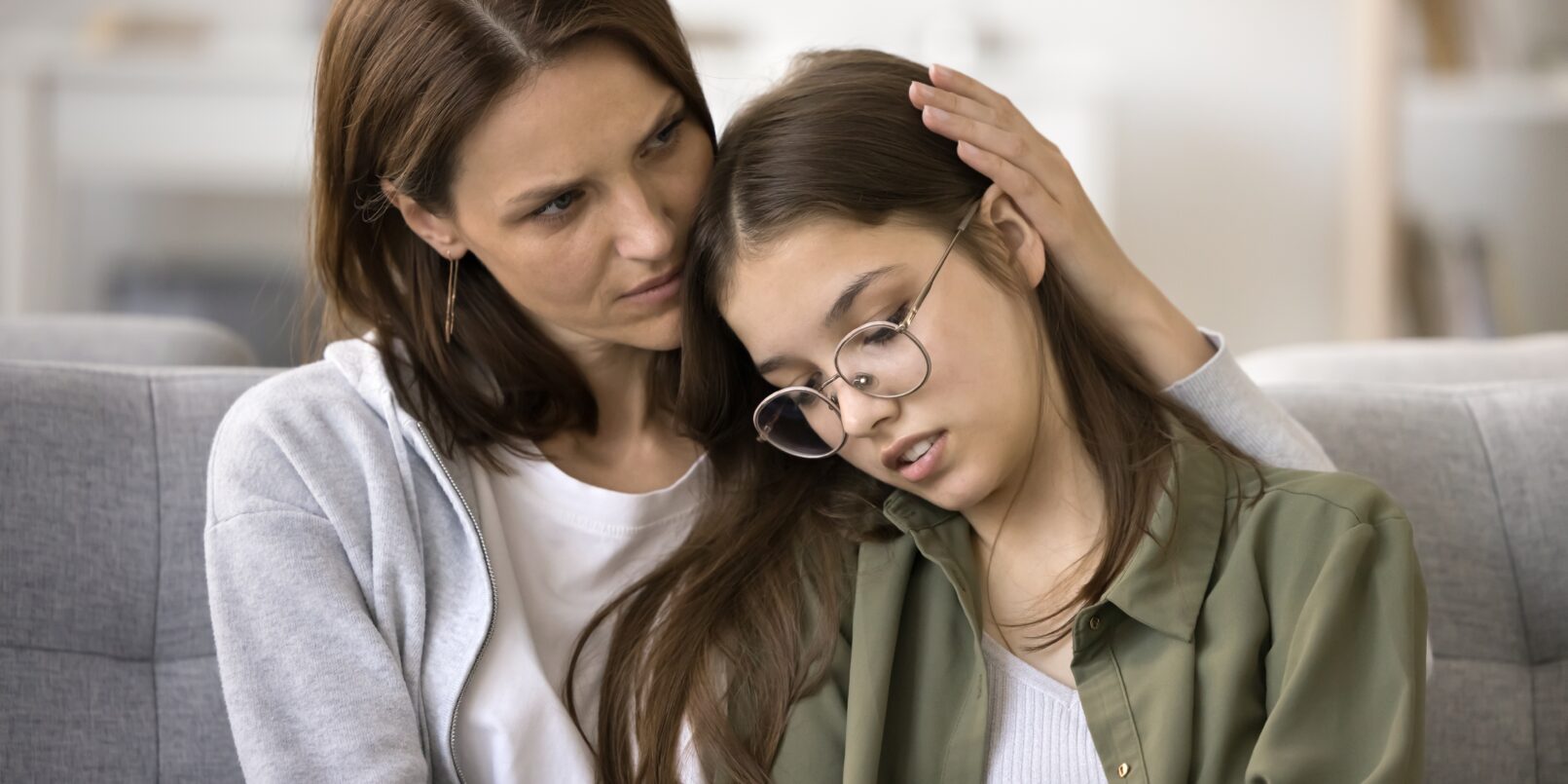 mother hugging teen daughter