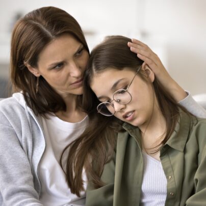 mother hugging teen daughter