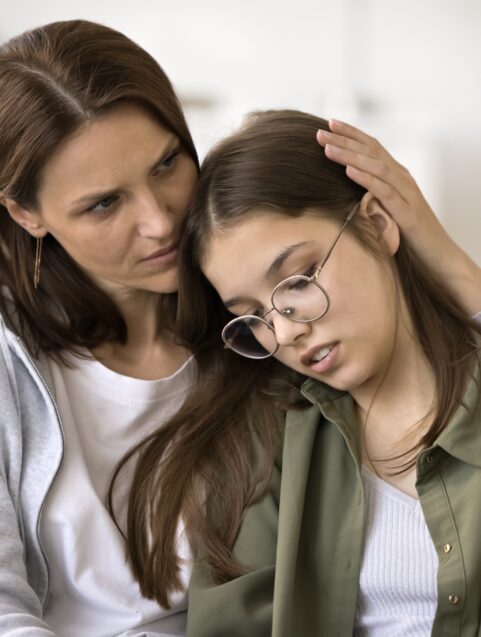 mother hugging teen daughter